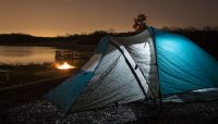 a tent and campfire at dusk at Camp Bullfrog Lake