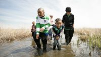 children exploring a wetland at Bartel Grassland