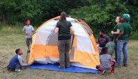 people setting up a tent at a Camping 101 event