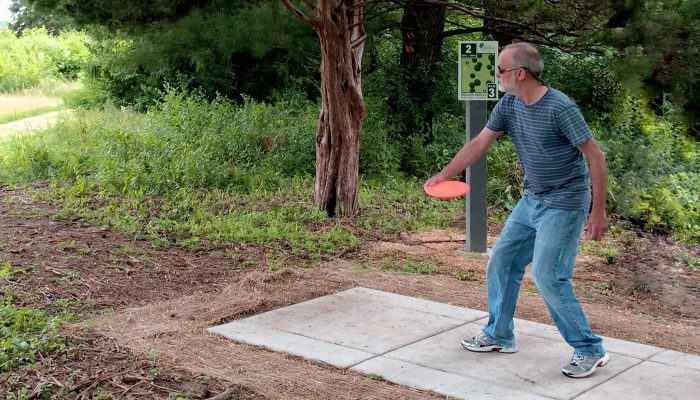 a person playing disc golf at Rolling Knolls