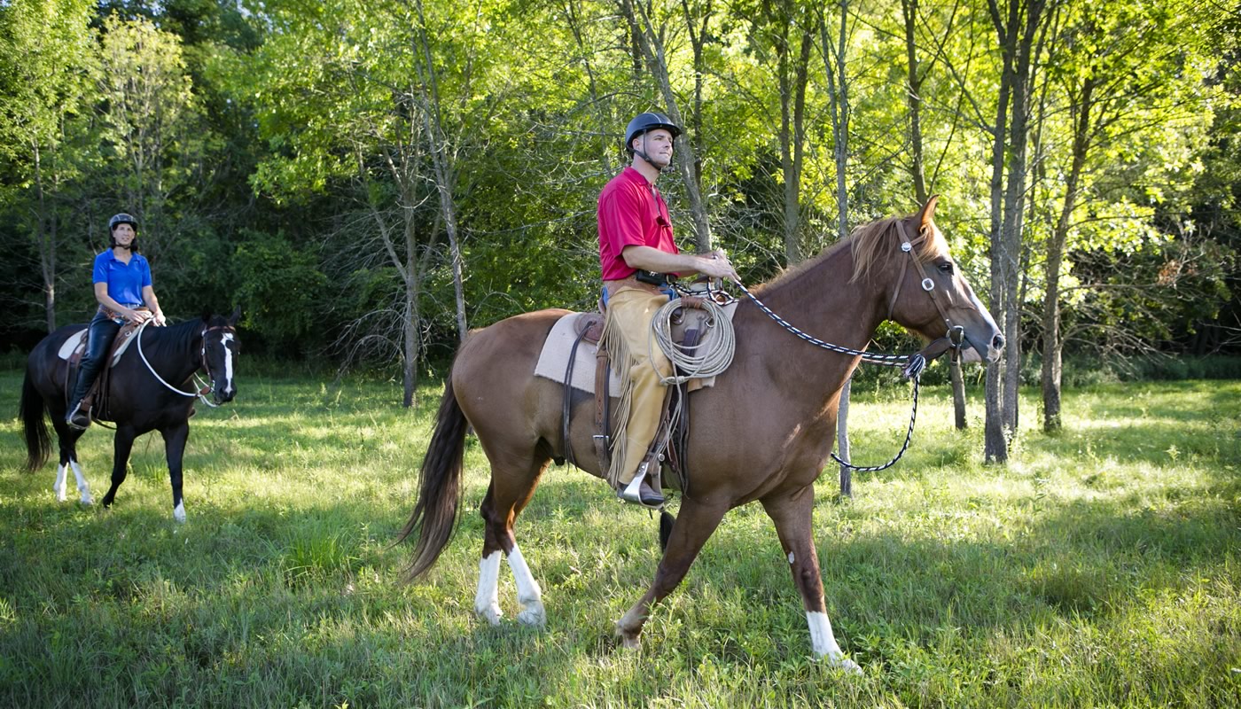 two people riding horses at Spring Lake