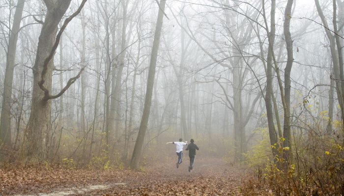 two people running on a foggy day at Cap Sauers Holding Nature Preserve