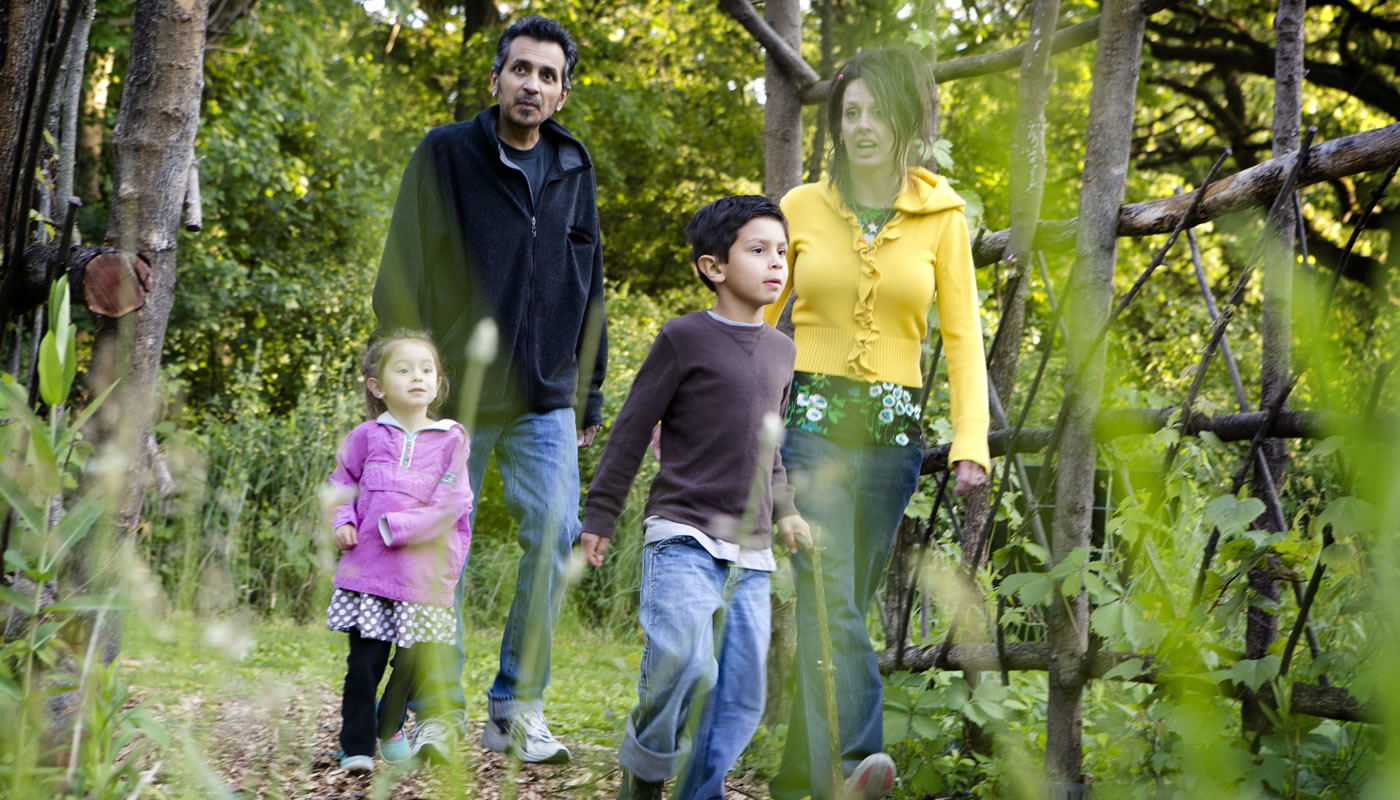 a family exploring the trails at Crabtree Nature Center