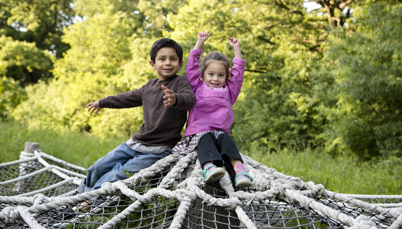 two children in the nature play area at Crabtree Nature Center