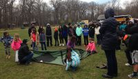 People putting up a tent at a Camping 101 event.