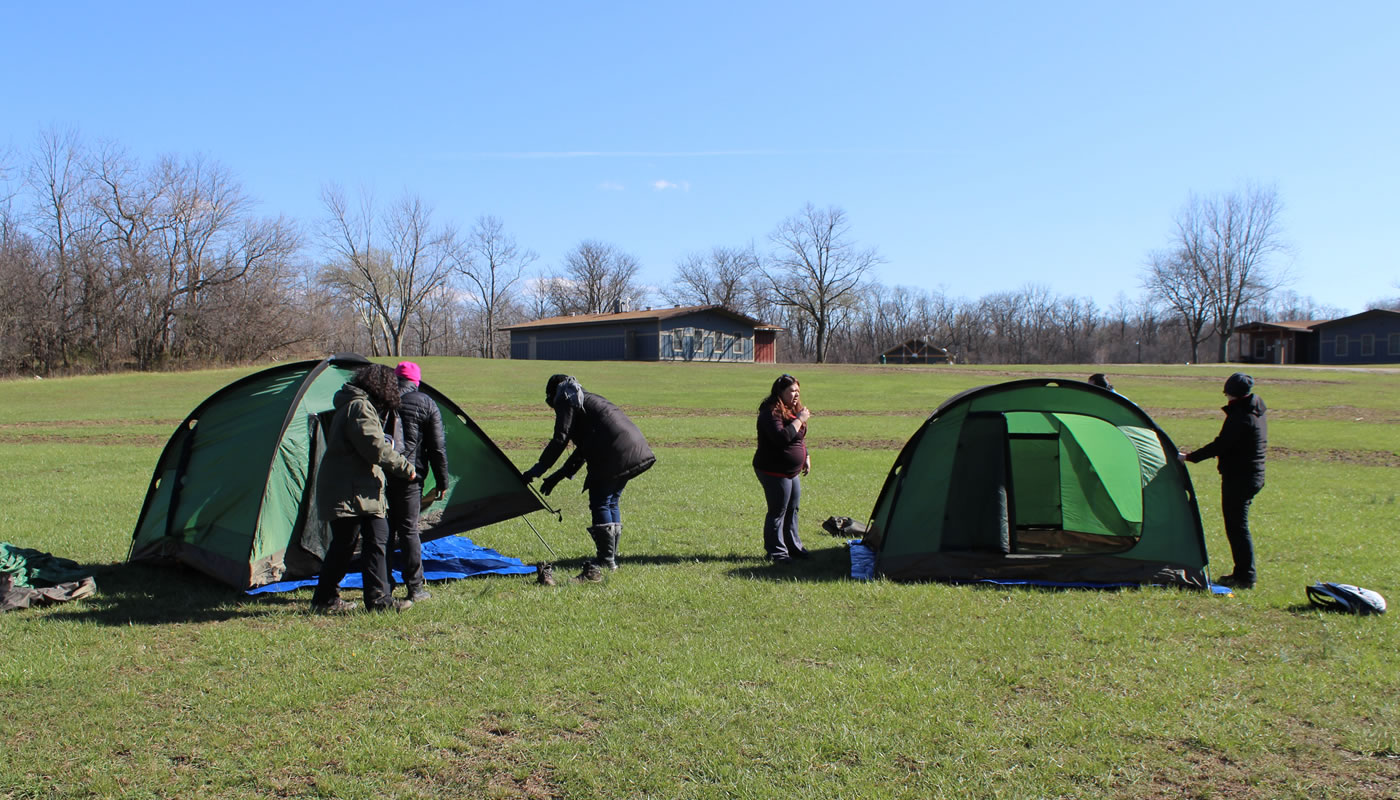 People setting up two tents during a CLIC training at Camp Sullivan.