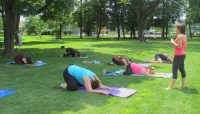 people participating in an outdoor yoga class