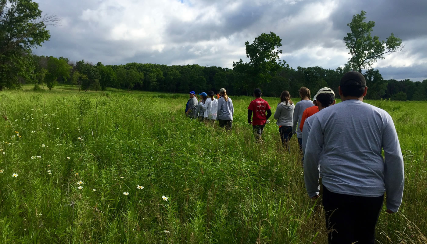 a group walks through a prairie