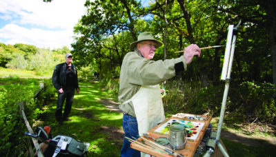 a person painting outside at Crabtree Nature Center
