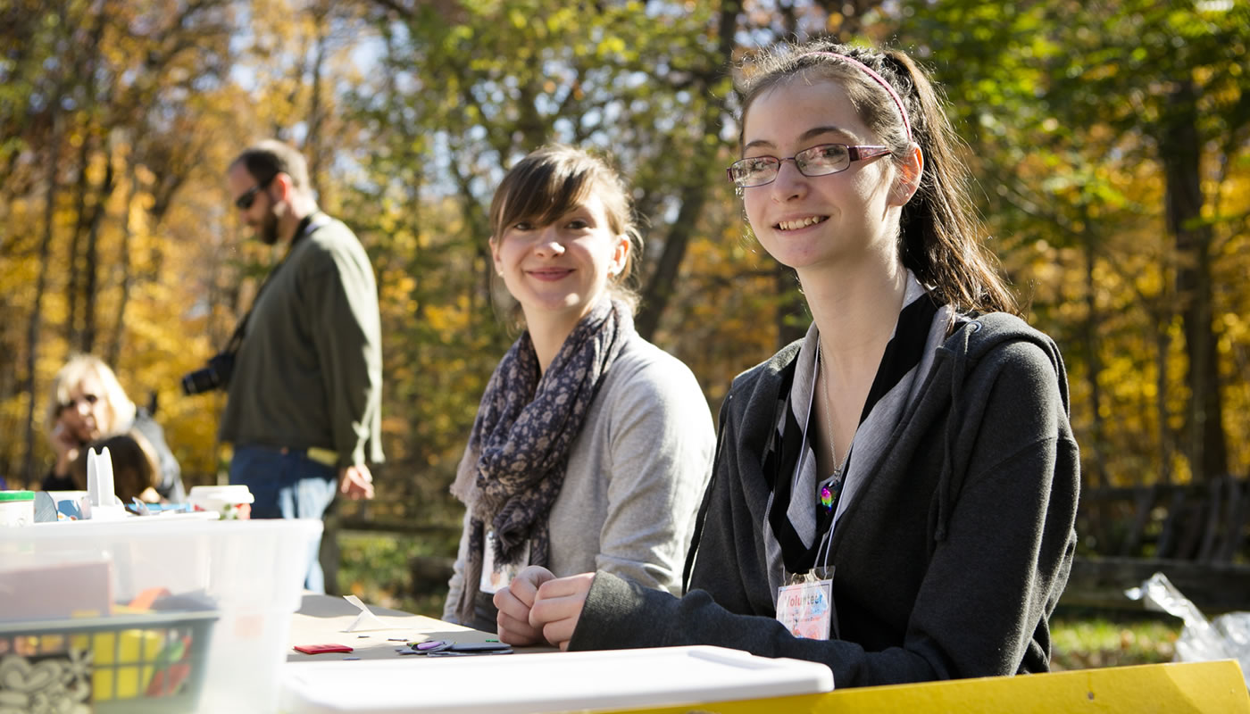 two volunteers leading a craft activity at River Trail Nature Center