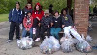 a group of volunteers with full trash bags
