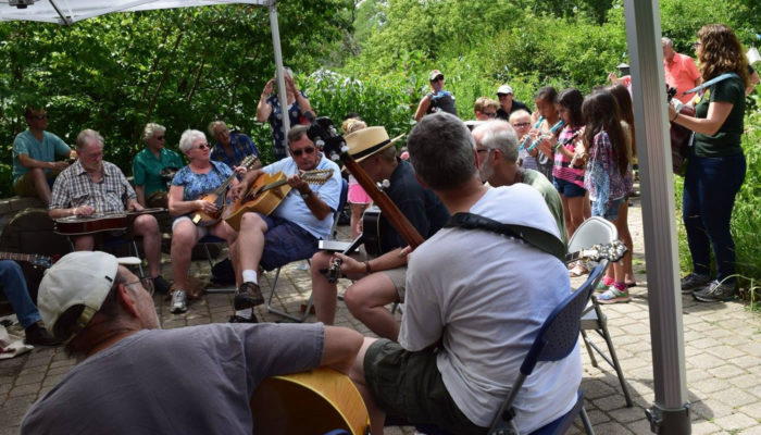 people playing various instruments at a blugrass jam at Trailside Museum