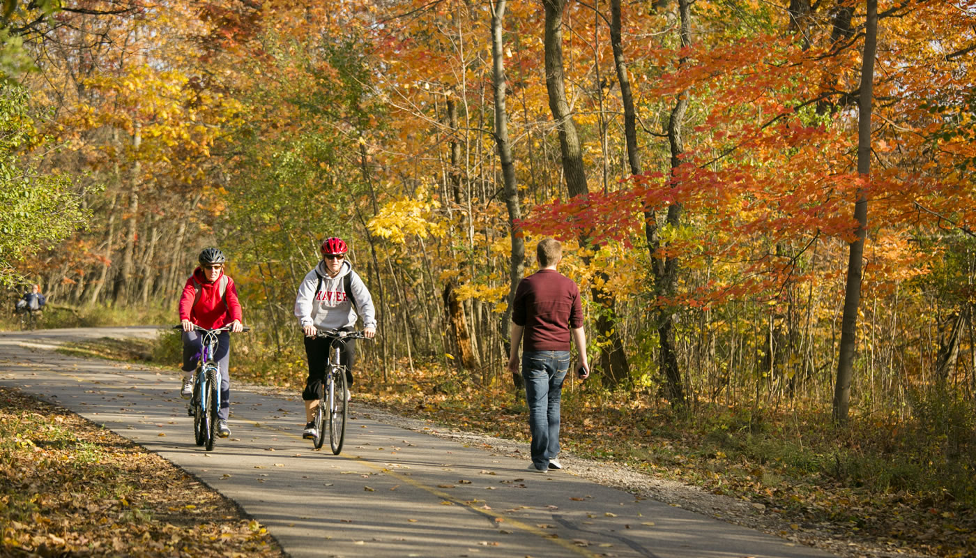 People biking and walking on the North Branch Trail at Bunker Hill in fall.