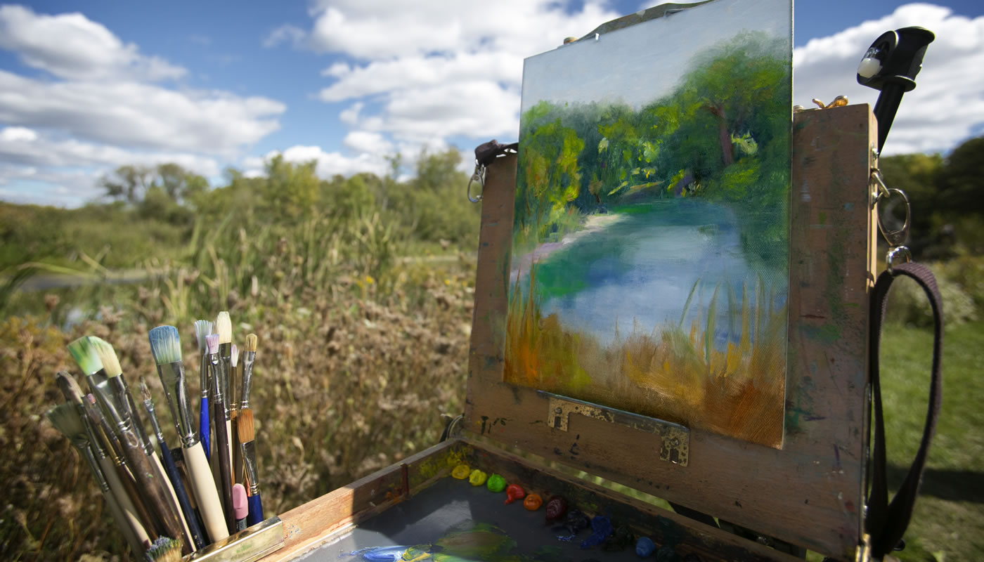 paint brushes and a canvas outside at Crabtree Nature Center