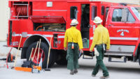 two firefighters walking toward a fire truck