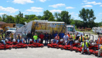 Forest Preserves employees posing with new propane mowers