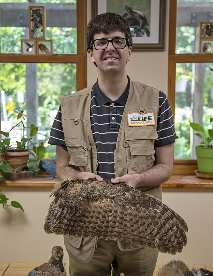 Charlie displaying an owl's wing at River Trail Nature Center