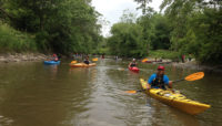 people in kayaks cleaning up the Little Calumet River