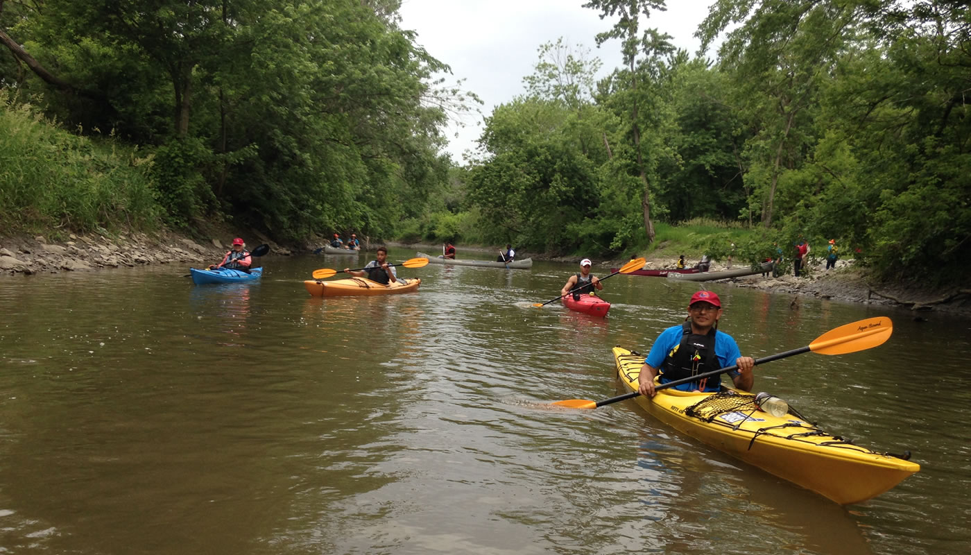 people in kayaks cleaning up the Little Calumet River