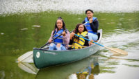 three people in a canoe at Beaubien Woods