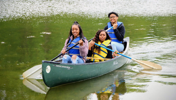 three people in a canoe at Beaubien Woods