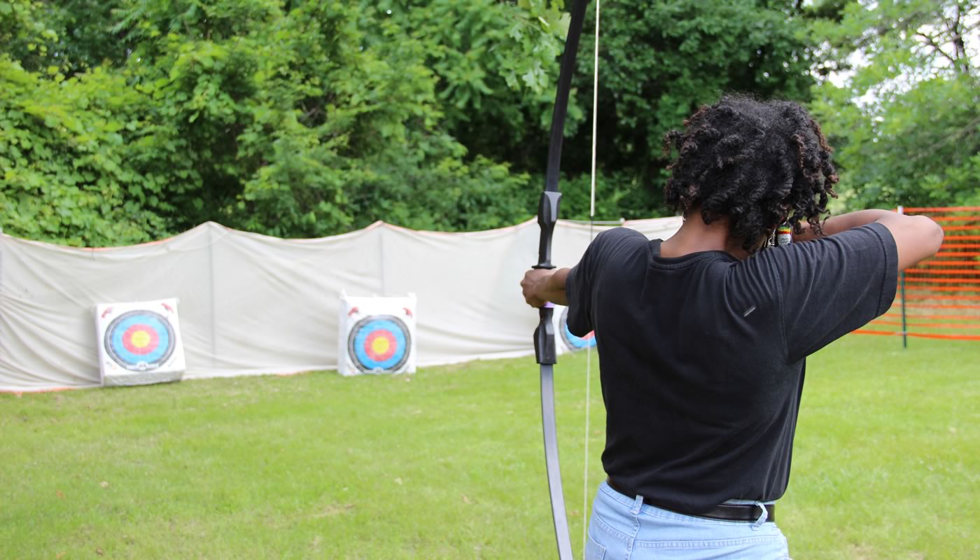 a person participating in archery at Beaubien Woods