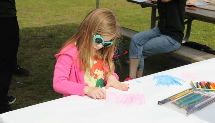 a girl coloring on a table at Eggers Grove