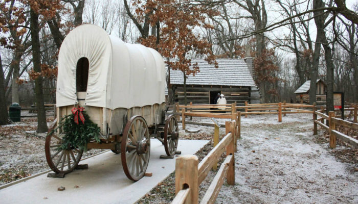 a replica pioneer wagon decorated for Christmas at Sand Ridge Nature Center