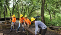 Chicago Conservation Leadership Corps crew members work on constructing a boardwalk