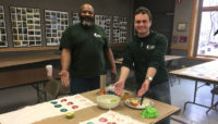 two Forest Preserves staff members demonstrating print making techniques at Sand Ridge Nature Center