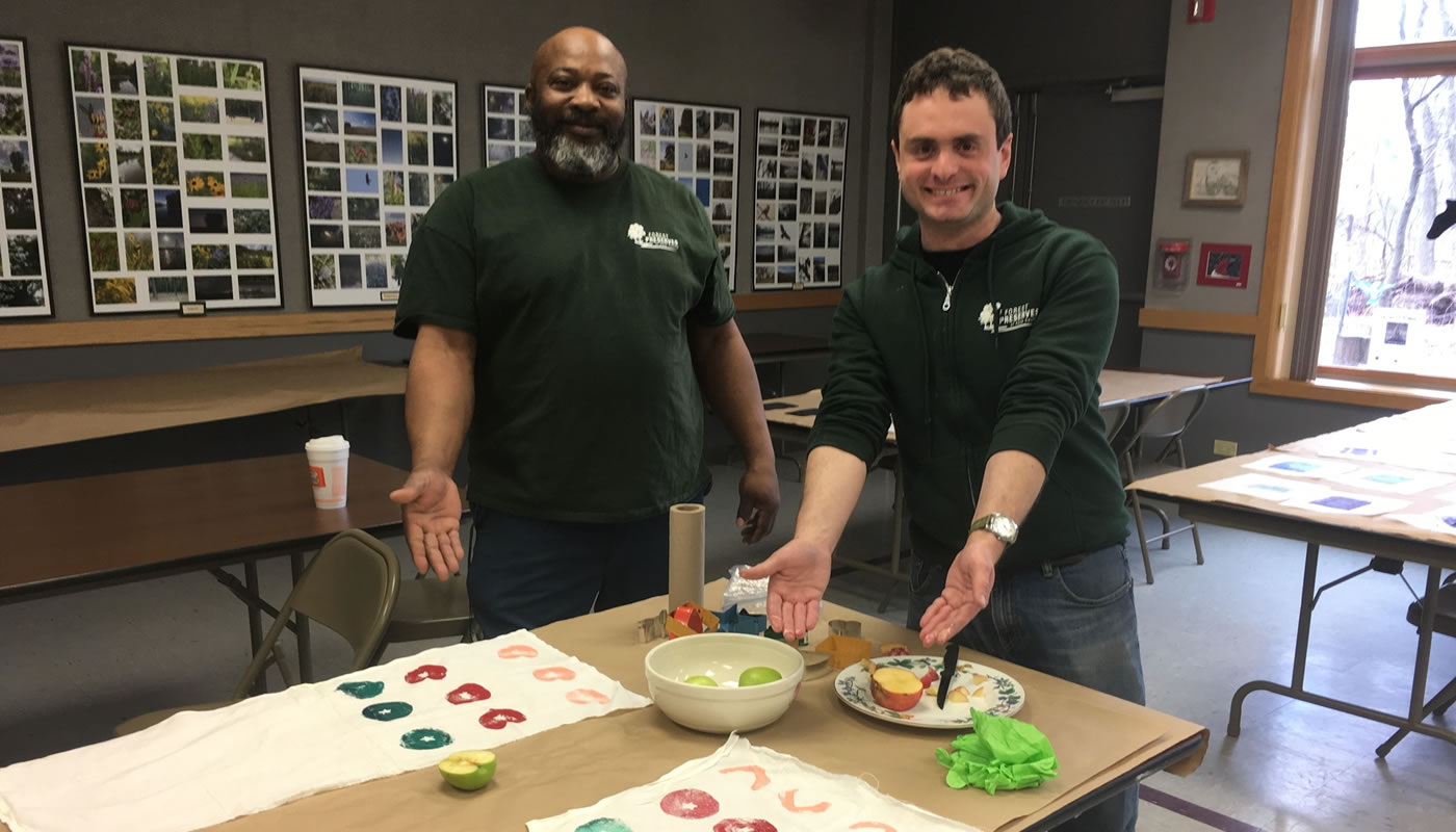 two Forest Preserves staff members demonstrating print making techniques at Sand Ridge Nature Center