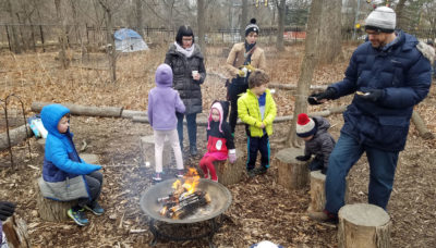 people around a campfire roasting marshmallows at Trailside Museum