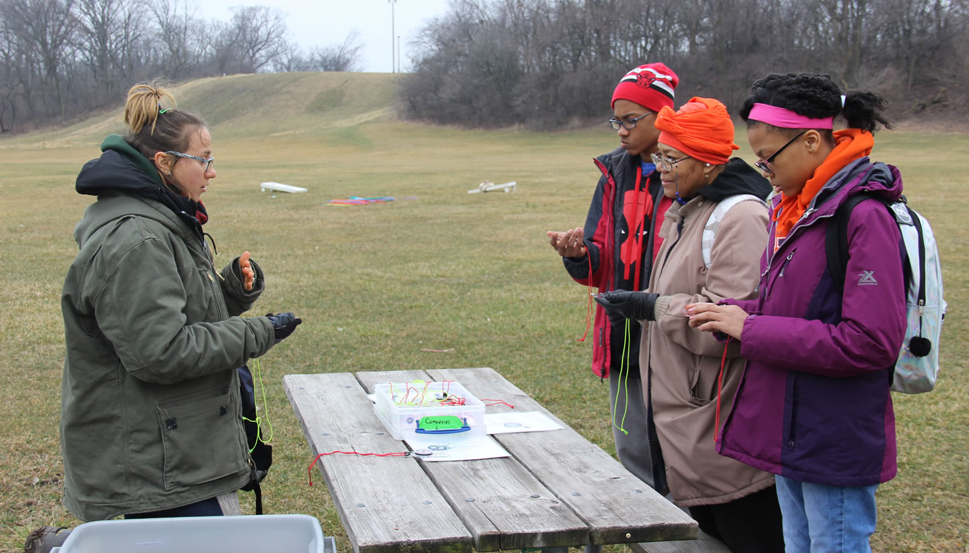 a group learning orienteering at Dan Ryan Woods