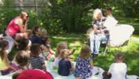 a Forest Preserves staff member reading a story to a group of children at Trailside Museum