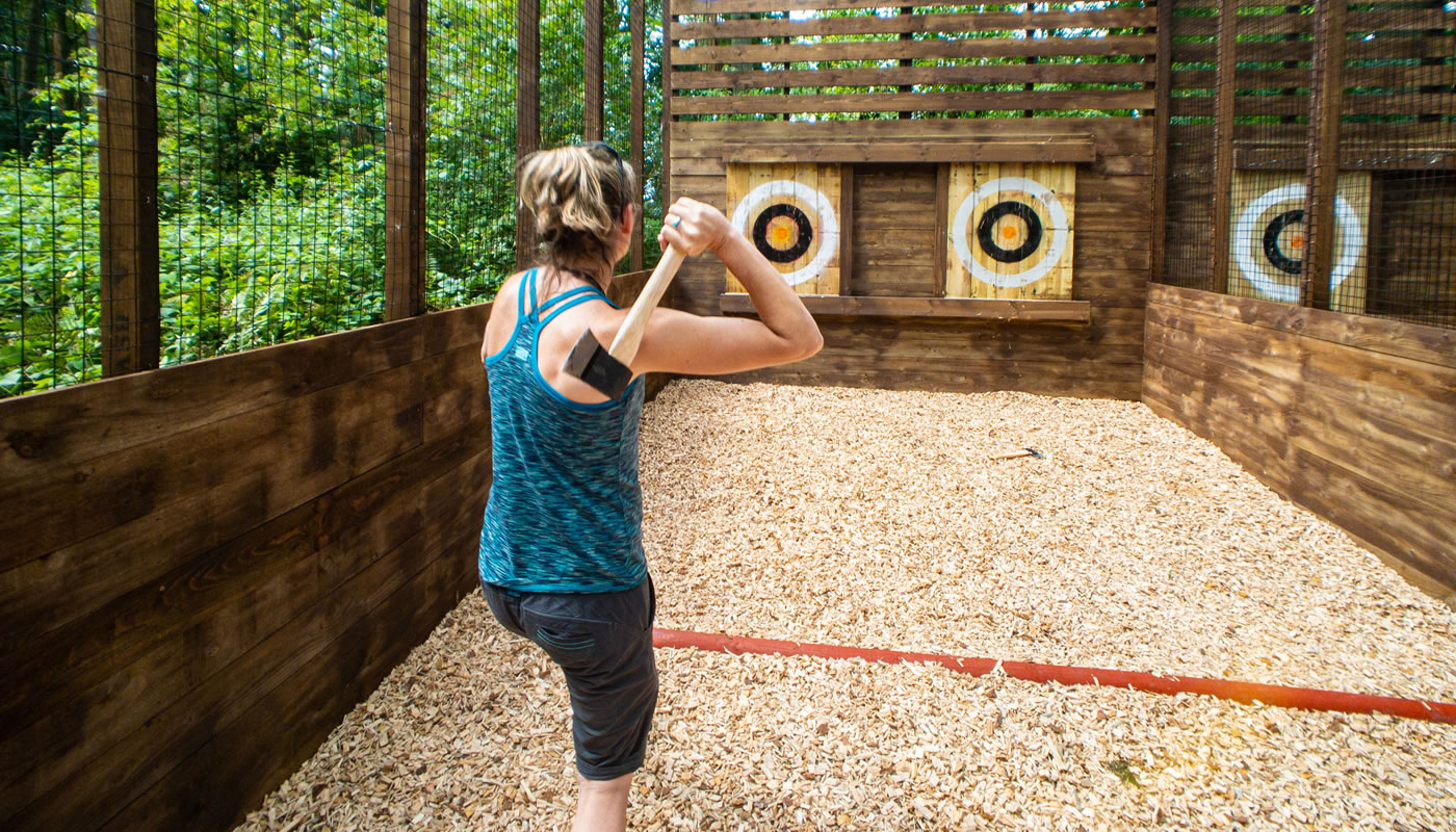 a person throwing an axe at the Go Ape Zipline & Adventure Park