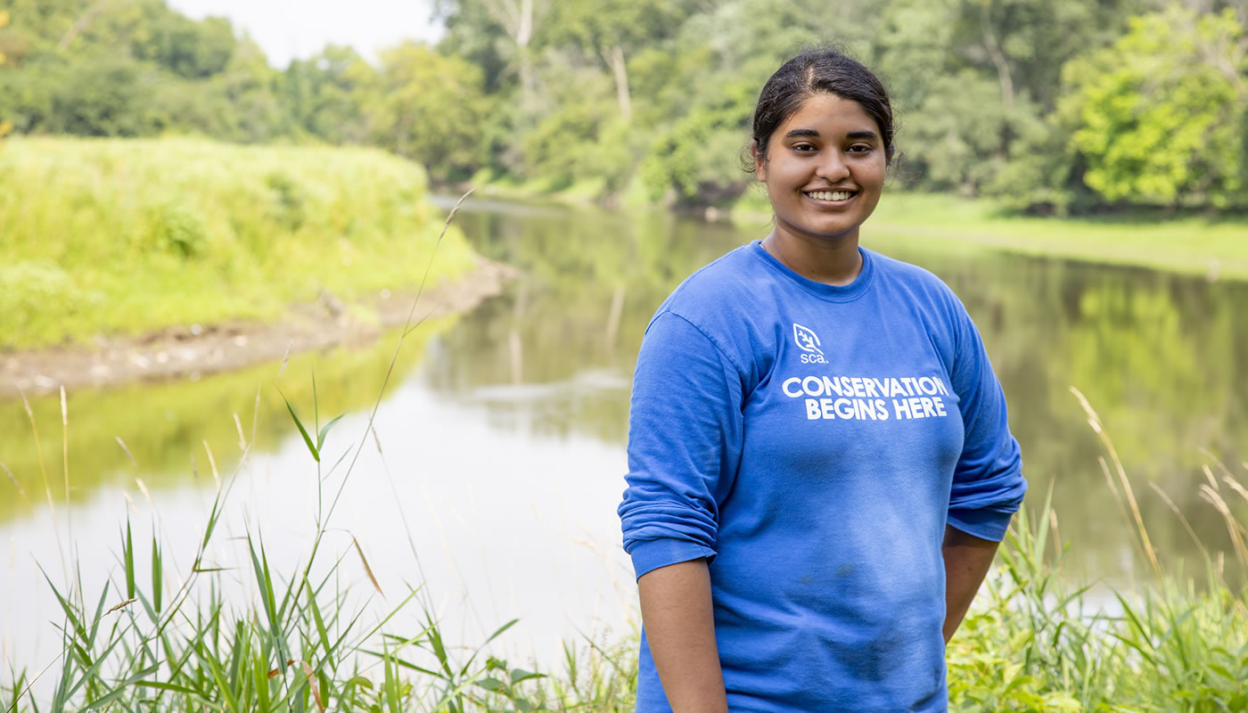 Lauren Lype next to a river in the Forest Preserves of Cook County.