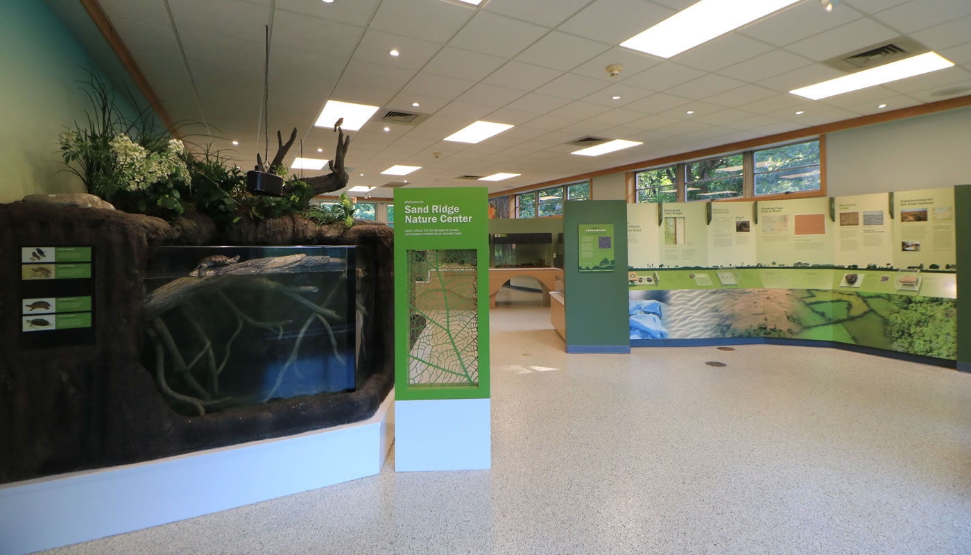 inside the Sand Ridge Nature Center exhibit room showing educational exhibits and turtles