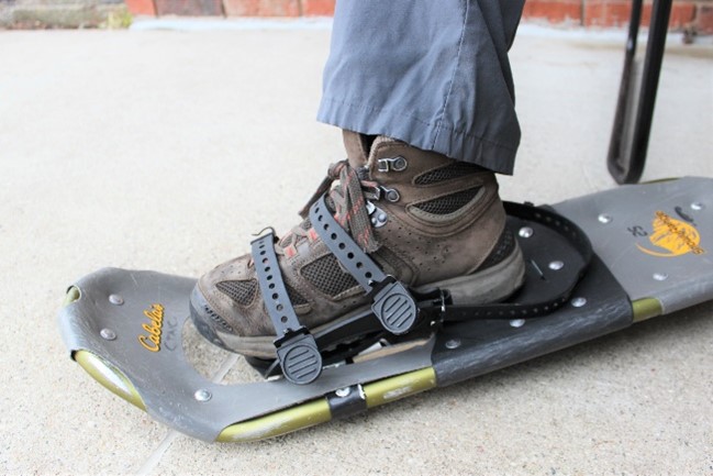 Inserting foot into a snowshoe