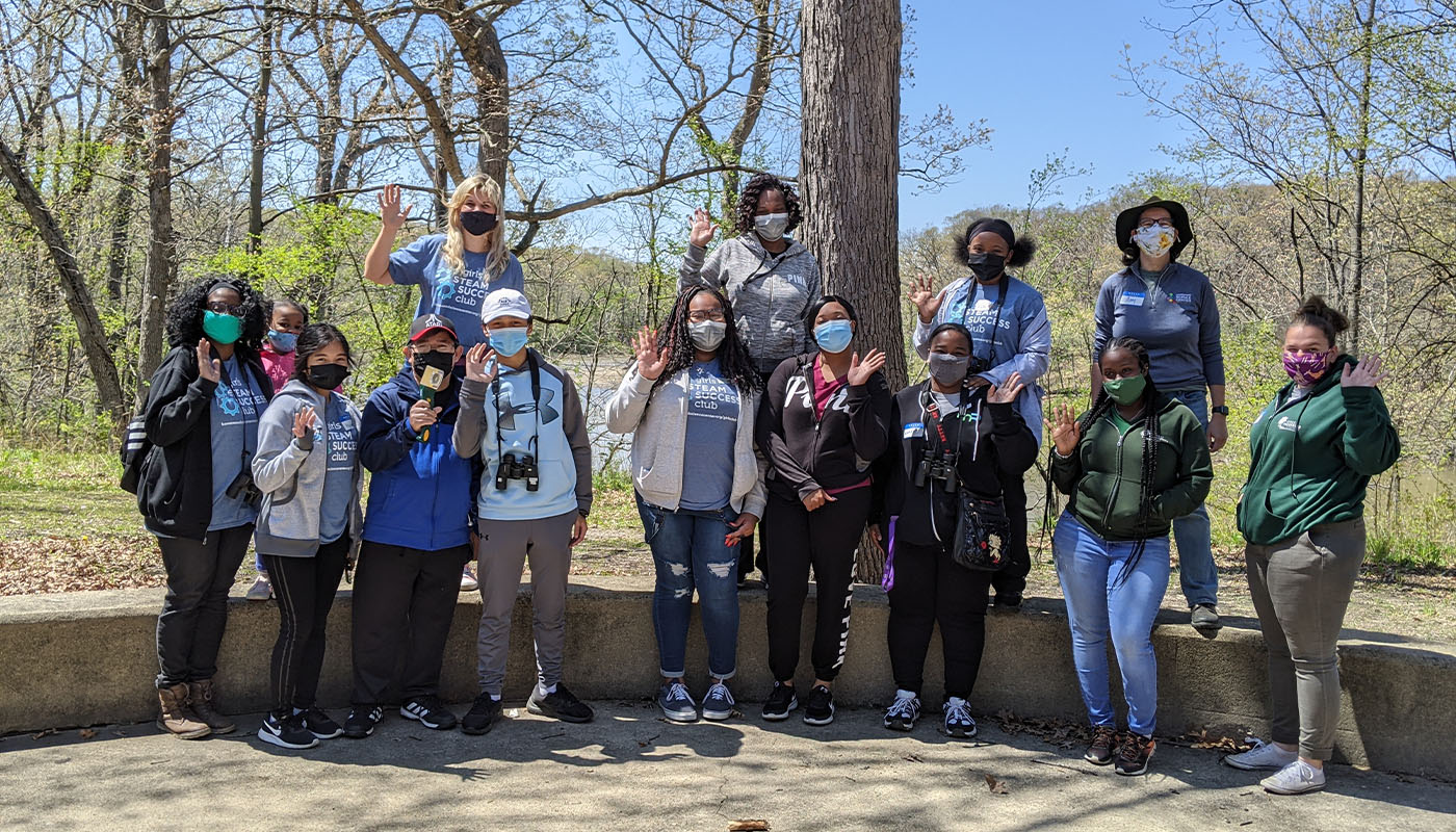 a group of people from the Homewood Science Center's Girls STEAM Success Club at Sauk Trail Woods