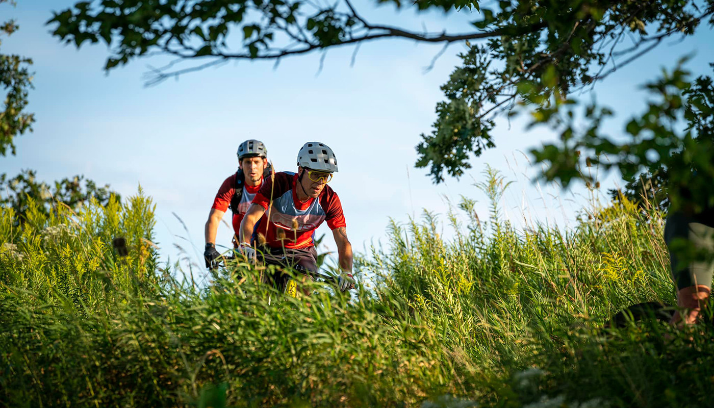 Mountain bikers navigate a single track trail.