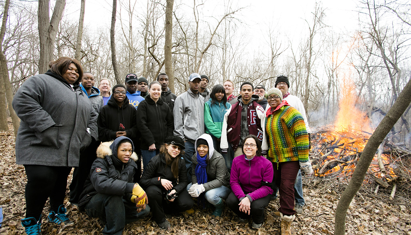 A group of volunteers posing for a photo after helping to remove invasive species from Dan Ryan Woods.