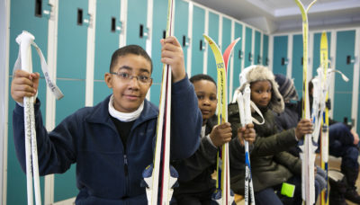 Children with skis at Sagawau Environmental Learning Center.