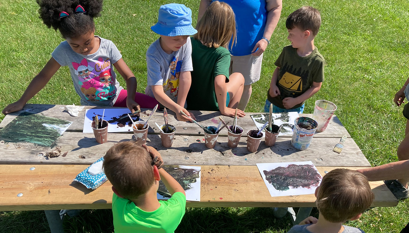 Children creating art at an International Mud Day event.