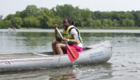 A youth canoeing at Wampum Lake