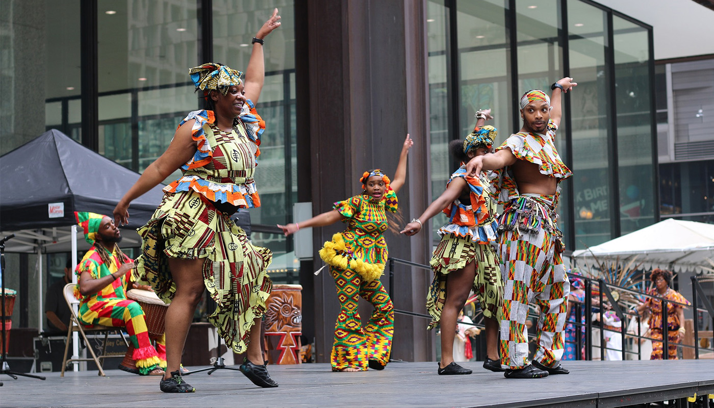 Dancers performing on an outdoor stage.