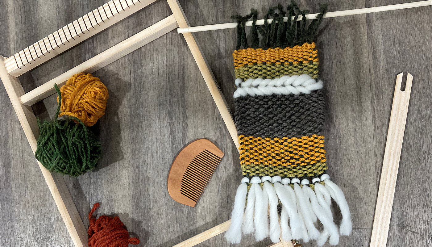 A set of weaving materials and tools.