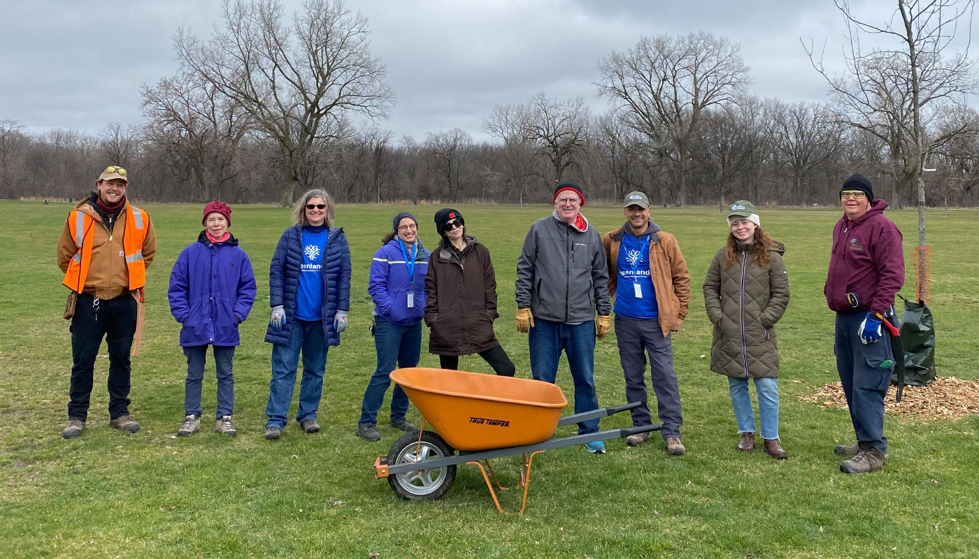 A group of volunteers at a picnic grove with tree maintenance tools and equipment.