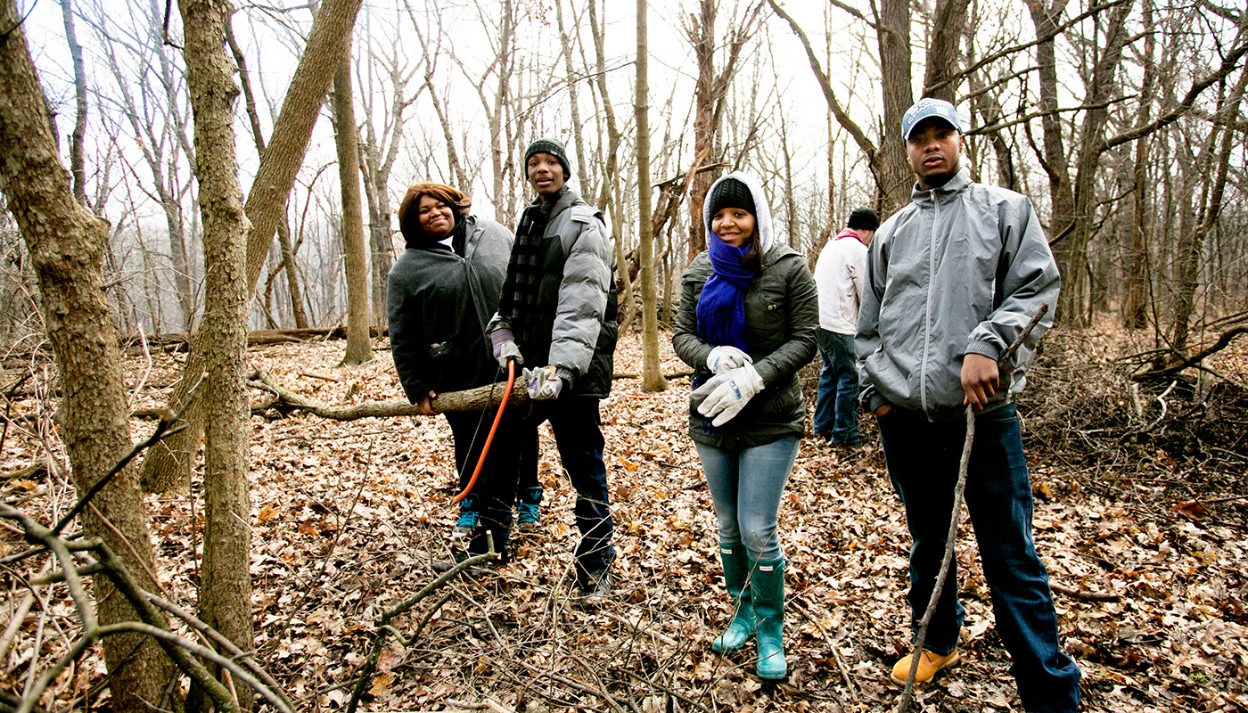 a group of people standing in the woods