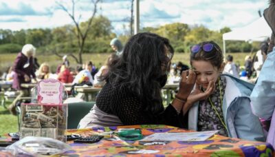 A family face painting at an event.