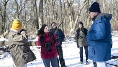 A group of photographers in a snowy landscape.